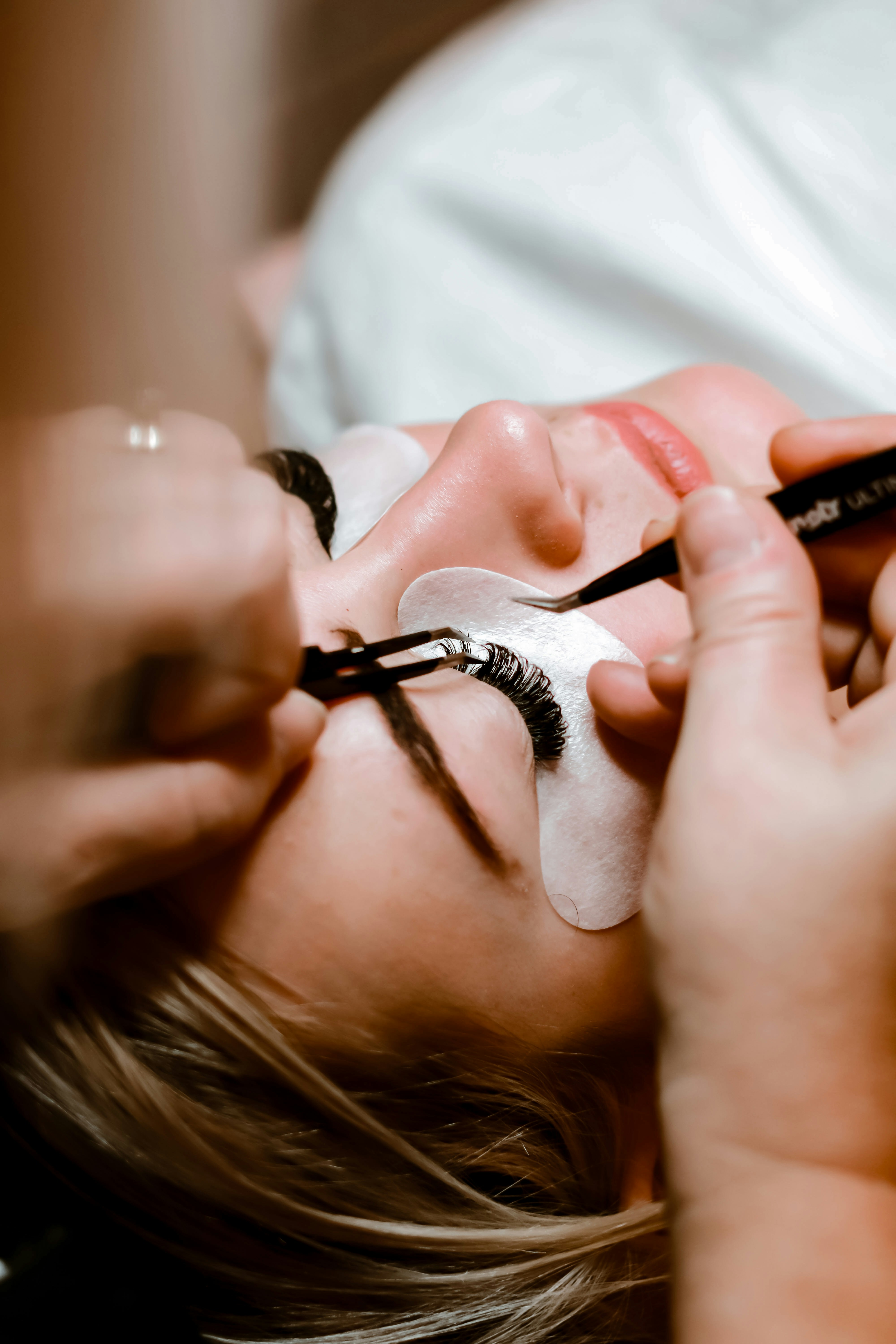 Before and after comparison of lash lift and tint treatment showing dramatic improvement